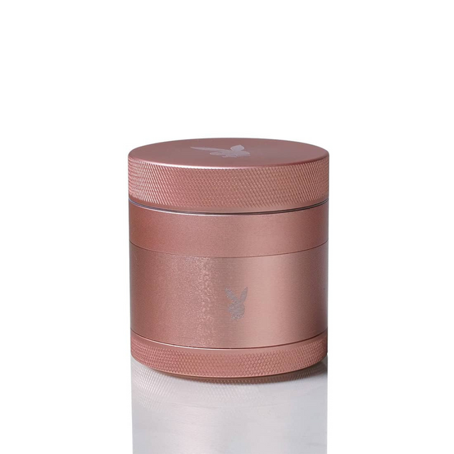 Close-up of the PLAYBOY x Kannastor 2.2 Grinder, showcasing its rose gold cylinder design, modular 4-piece build, and engineered drop-through system.