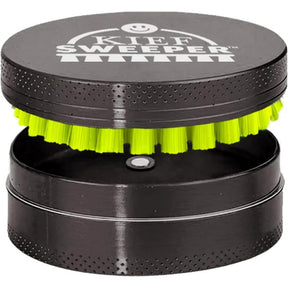Compact Kief Sweeper Brush: small, two-piece cylindrical tool with lime-green bristles, designed to scrape and collect kief efficiently from herb grinders. Durable aluminum, twist-to-clean design.
