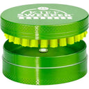 Compact Kief Sweeper Brush: metal two-piece grinder with smiley logo lid, revealing nylon-bristle brush and lower chamber for collecting sifted kief, ensuring smooth, efficient use.