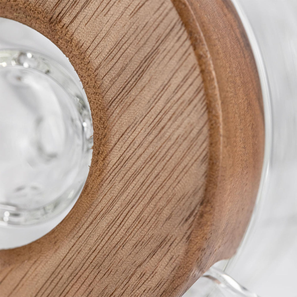 Close-up of the Apex Dab Rig - Alpine Collection, highlighting the milled black walnut ring accenting its glass surface for refined style and performance.