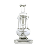 Claude Mini Dab Rig - Clear: A compact glass recycler water pipe featuring looping tubes, central chamber, and flared mouthpiece, crafted for smooth, efficient vapor filtration.