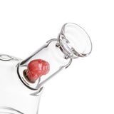 Close-up of the MJA x Tyson 2.0 Punch-Out Bubbler, highlighting the clear glass body and internal red glass percolator.