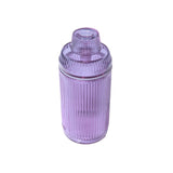 Deco Gravity Bong, a ribbed, translucent lavender-purple glass shaker with a matching lid, showcasing vintage elegance and modern functionality in a sculptural design.