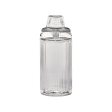 Deco Gravity Bong: A tall, cylindrical clear glass container with fluting, topped by a ribbed lid. Combines Art Deco elegance with modern gravity-powered functionality.