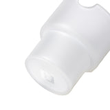 Close-up of a milky-white plastic cap, embossed with H, resembling a diffuser for the Flower Pots Ashtray Set, showcasing minimalist design and functionality.