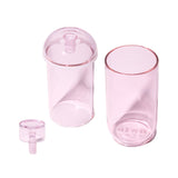 Vesper Gravity Bong featuring three matching pink translucent pieces: a tall tumbler, a shorter cylinder with a domed lid, and a funnel-shaped stopper.