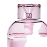 Vesper Gravity Bong, a sleek, pink-tinted glass container with a stopper, showcases a vintage-inspired, modern design for smooth, effortless smoking.