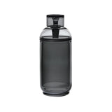 Vesper Gravity Bong, a sleek, smoke-gray cylindrical container with a matching lid, crafted from premium borosilicate glass, designed for smooth, gravity-powered smoking.