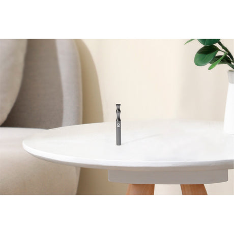 Aluminum Taster Bat: Close-up of a compact, cylindrical smoking tool on a table, showcasing its sleek, durable design for discreet, portable smoking.