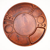 Spinning Rolling Tray: Circular wooden platter with recessed compartments, central well, and rotating base, designed for organized display of various foods or accessories.
