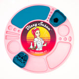 Spinning Rolling Tray: Round pink silicone tray with multiple compartments for organizing cannabis accessories, featuring a Blazy Susan logo and removable teal inserts.
