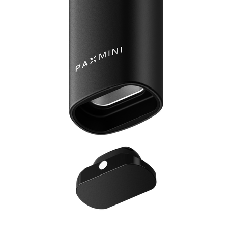 PAX Mini portable vaporizer, showing black aluminum body with logo, alongside detached magnetic mouthpiece/oven lid, highlighting compact design and intelligent heat control features.