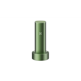 PAX FLOW vaporizer in olive-green sits in its matching charging dock, showcasing its X LED indicator, epitomizing advanced dry herb vaping technology.