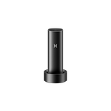 PAX FLOW vaporizer in charging cradle with visible PAX logo, showcasing its sleek, portable design and advanced technology for dry herb vaping.
