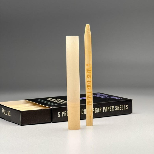 Small Shell Cones - Carton of 20: A box containing pre-formed paper shells designed for crafting premium cannagars, visible with a pencil for scale.