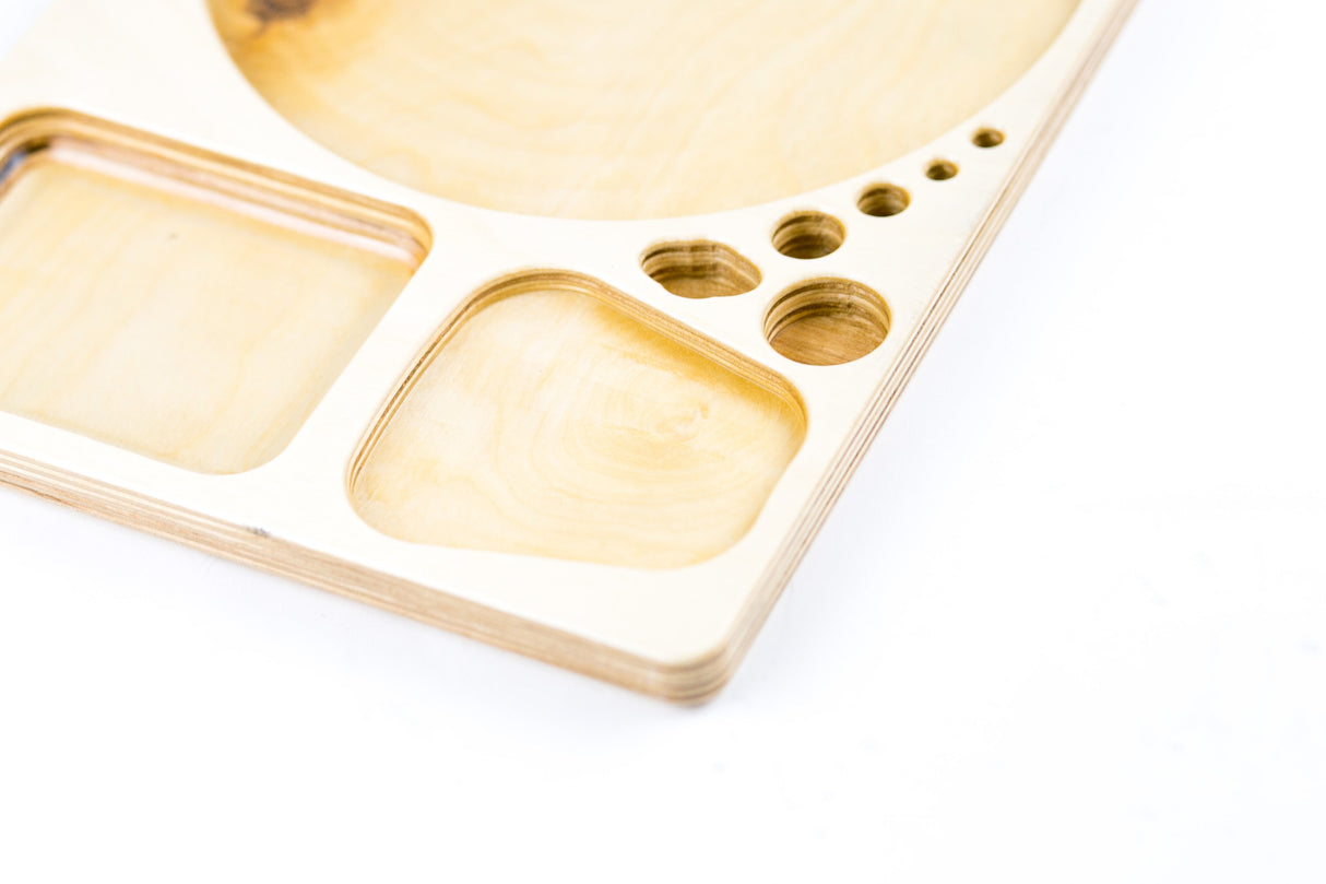 Blazy Susan Dab Tray: CNC-cut birch organizer with multi-compartment layout, featuring wells and holes for efficient, compact desk use.