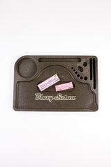 Hemp Plastic Rolling Tray with pink Blazy Susan paper packs, featuring a compartmentalized design for organizing smoking essentials, crafted from durable, biodegradable hemp plastic.