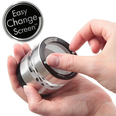 Kannastör 2.2 Multi-Chamber Grinder with Easy Change Screen, demonstrating mesh insert removal for cleaning. Durable, magnetic design ensures a precise, mess-free grind.