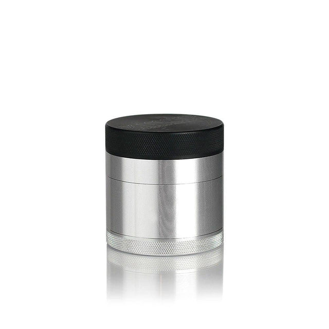 2.2 Kannastör Multi-Chamber Grinder - Silver, showing its cylindrical design with knurled base, grinding chamber, black lid, and magnetic closure for precise herb grinding.
