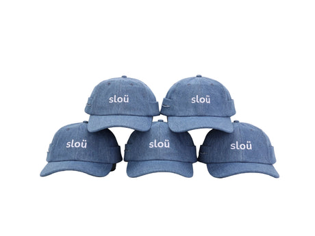 Five blue Slou roller caps arranged together, each featuring a curved brim and white Slou logo embroidered on the front