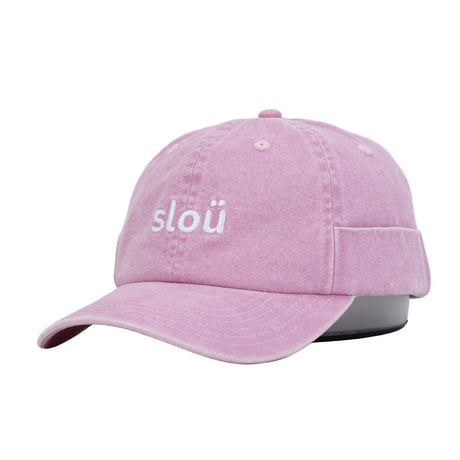 A light pink washed cotton rollerscap with the word slou embroidered in white on the front, displayed on a black mannequin head