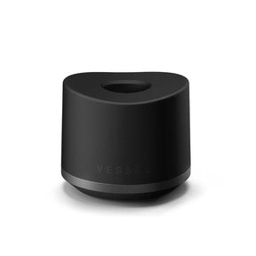Base Charger - Black: Matte-black cylinder with recessed top for wireless charging of compatible Vessel smart mugs, featuring a weighted, non-slip design for stability.