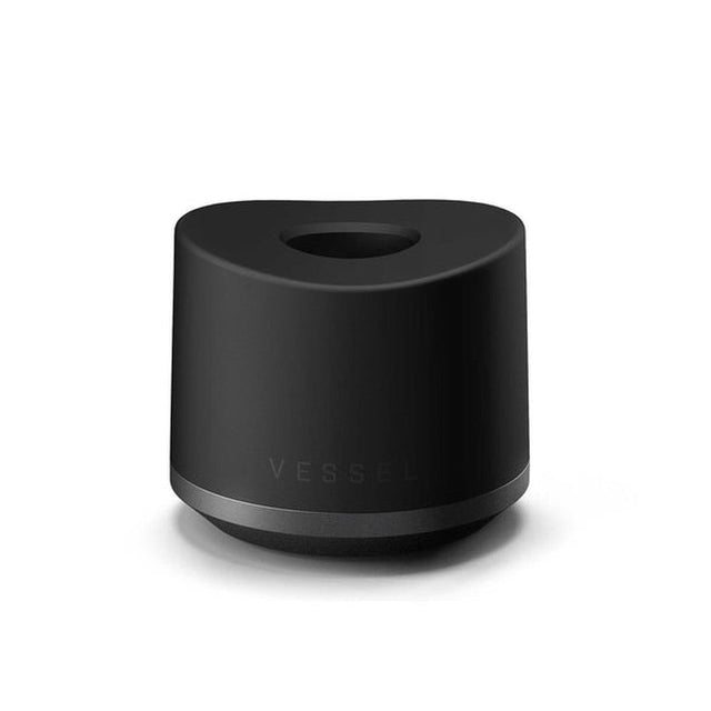 Base Charger - Black: Matte-black cylinder with recessed top for wireless charging of compatible Vessel smart mugs, featuring a weighted, non-slip design for stability.