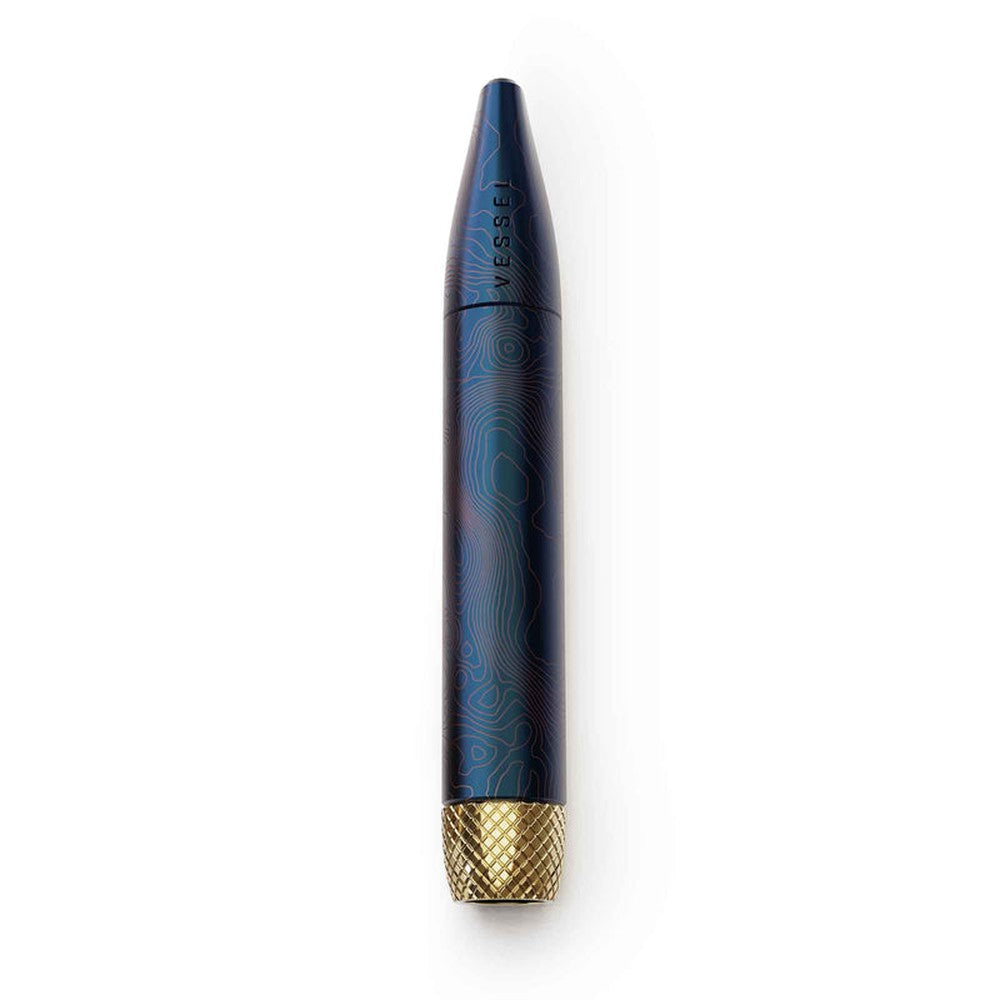 Helix Premium One Hitter, a blue topographic-patterned metal capsule with VESSEL branding and a knurled brass cap, designed for enhanced airflow and cooling.