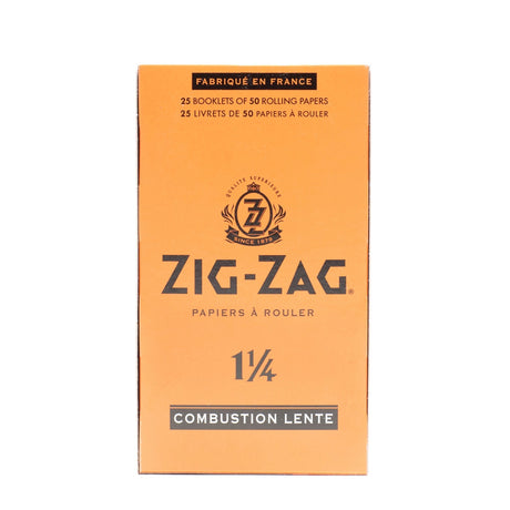Zig-Zag 1 1/4 Orange Rolling Papers box, featuring a close-up of the logo and packaging details, highlighting premium natural flax plant fibers and slow-burning quality.