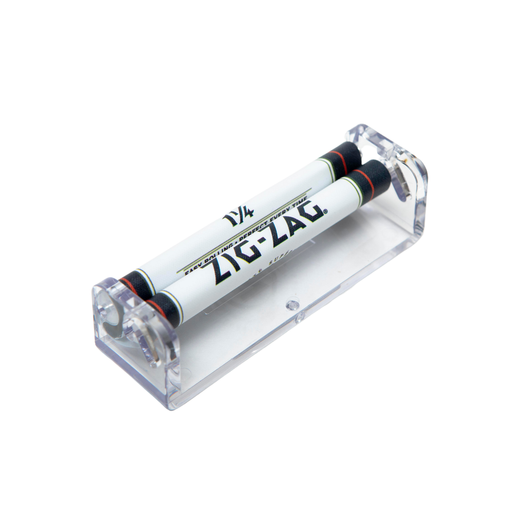 1 1/4 Rolling Machines 78 mm - Carton of 12; clear plastic device with dual rollers for efficiently packing and rolling tobacco, ensuring uniform results.