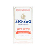 Single Wide White Kutcorners Rolling Paper box featuring Zig-Zag branding and text, highlighting natural flax fibers and gum Arabic for slow burning and easy rolling.