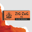 Zig-Zag 1 1/4 Orange Rolling Paper box featuring a logo and text, designed for a smooth, slow burn with natural flax plant fibers.